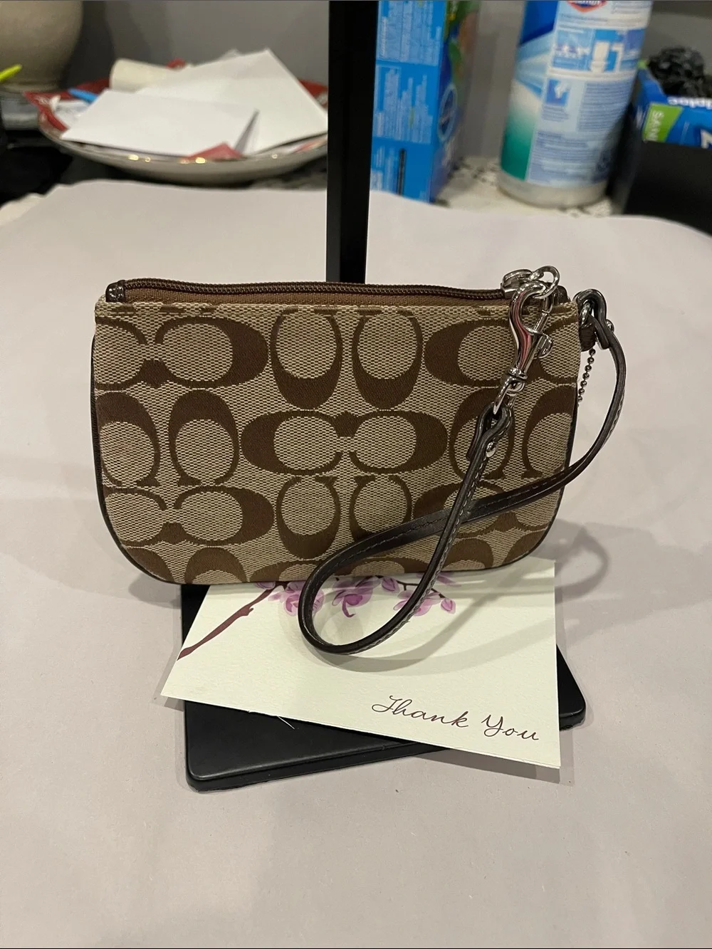 Coach Signature Small Wristlet in a khaki zipped coin purse